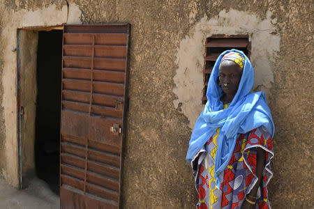 A woman stands outside a house at the site of an attack by gunmen on Fulani herders in Ogossagou, Mali, in this handout picture obtained by Reuters on March 26, 2019. Malian Presidency/Handout via Reuters