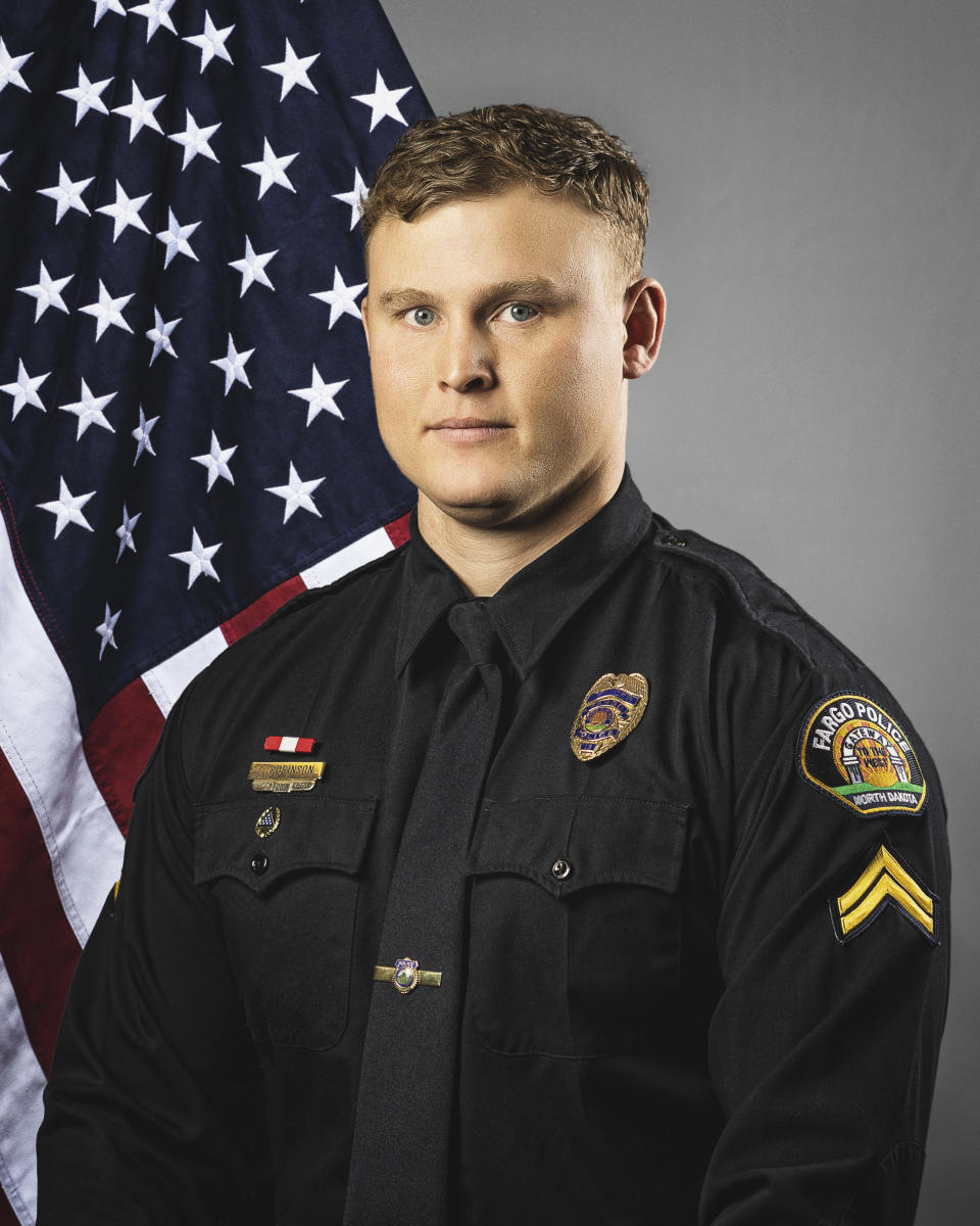 This photo provided by The City of Fargo, N.D., on Saturday, July 15, 2023 shows police officer Zach Robinson. On Saturday, Fargo's police chief said a gunman opened fire on police and firefighters as they responded to a traffic crash in North Dakota. One officer was killed and two others were wounded before a fourth officer, Robinson, killed him. (The City of Fargo via AP)