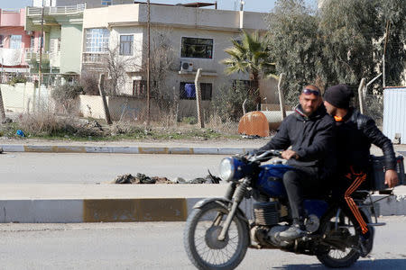 Men ride a motorcycle past bodies of Islamic State militants killed in clashes in Mosul, Iraq, February 6, 2017. REUTERS/Ahmed Saad