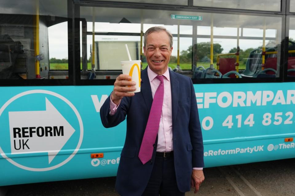 JAYWICK, ENGLAND - JUNE 4:  Reform UK party leader Nigel Farage holds a milkshake as he launches his election candidacy on June 4, 2024 in Jaywick, England. The launch follows yesterday's announcement that Nigel Farage will stand as an MP in Clacton at the 4 July general election and takes over from Richard Tice as leader of Reform UK. The Conservative-held seat in Essex was the first to elect a UKIP MP in 2014, a party that Farage founded. (Photo by Carl Court/Getty Images)