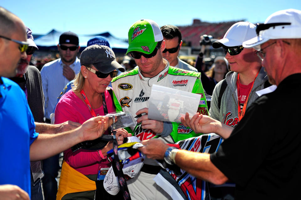 TALLADEGA, AL - OCTOBER 22: Dale Earnhardt Jr., driver of the #88 Diet Mountain Dew Chevrolet, signs autographs during qualifying for the NASCAR Sprint Cup Series Good Sam Club 500 at Talladega Superspeedway on October 22, 2011 in Talladega, Alabama. (Photo by Jason Smith/Getty Images)