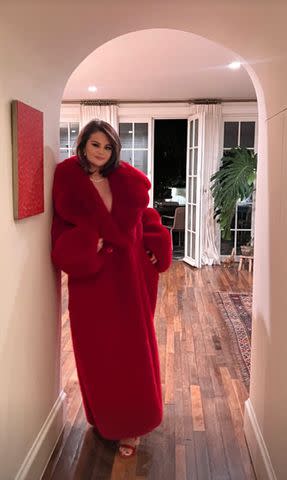 <p>Selena Gomez/Instagram</p> Selena Gomez poses in her red coat