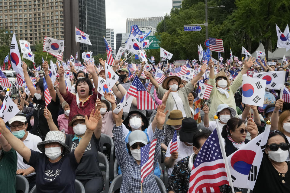 People cheer during a rally against North Korea on Korea's Liberation Day in Seoul, South Korea, Monday, Aug. 15, 2022. South Korean President Yoon Suk Yeol on Monday offered "audacious" economic assistance to North Korea if it abandons its nuclear weapons program while avoiding harsh criticism of the North days after it threatened "deadly" retaliation over the COVID-19 outbreak it blames on the South. (AP Photo/Ahn Young-joon)