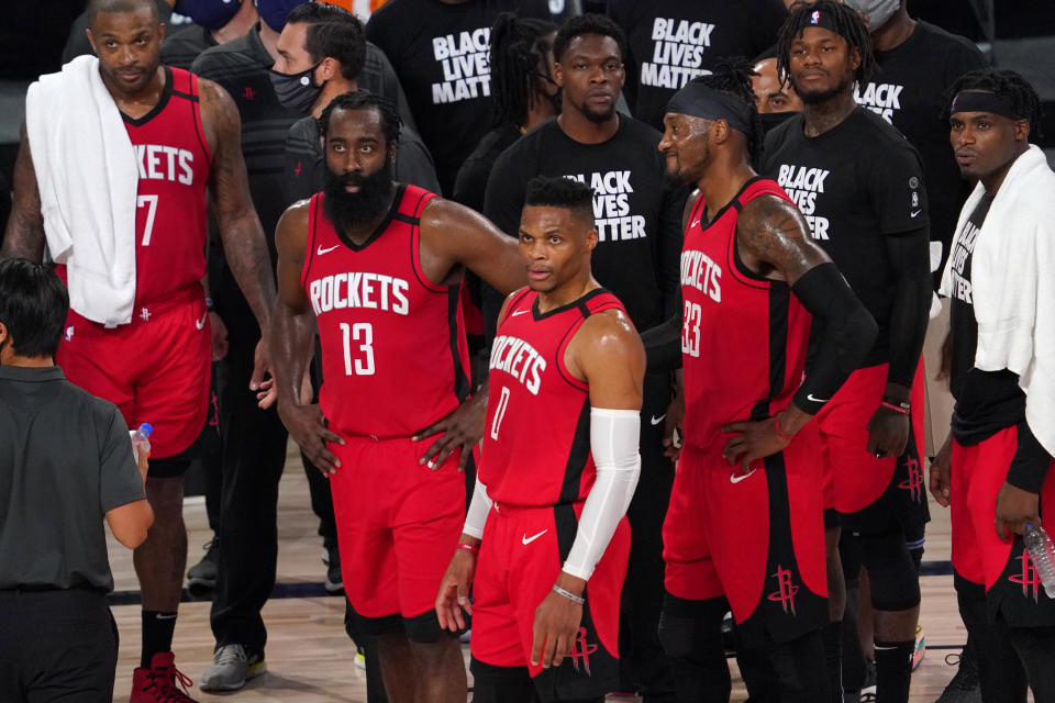 Houston Rockets' P.J. Tucker, from left, James Harden (13), Russell Westbrook (0), Robert Covington (33) and others look up at a video board to watcha replay during the second half of an NBA first-round playoff basketball game against the Oklahoma City Thunder on Monday, Aug. 31, 2020, in Lake Buena Vista, Fla. (AP Photo/Mark J. Terrill)