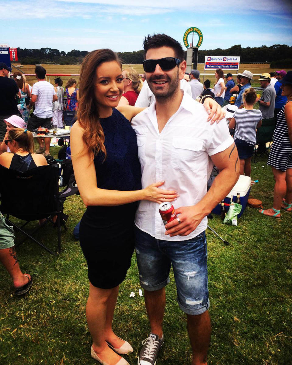 Melinda Willis with brunette hair posing with a man in a park