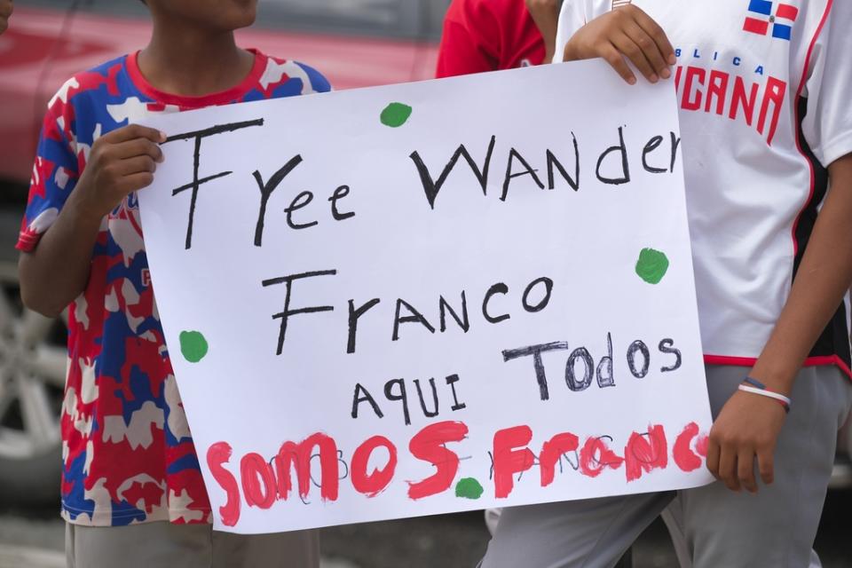 Youth baseball players from the local team “Liga deportiva Antera Mota” show support for Tampa Bay Rays shortstop Wander Franco with posters that read in Spanish: “Free Franco,” and “Here we’re all Franco.” outside the court where he arrived in Puerto Plata, Dominican Republic, Friday, Jan. 5, 2024. Dominican prosecutors on Wednesday accused Franco of commercial sexual exploitation and money laundering following allegations that he had a relationship with a minor whose mother also faces the same charges. (AP Photo/Ricardo Hernández)