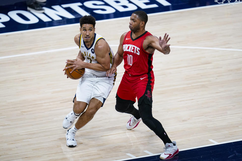 Indiana Pacers guard Malcolm Brogdon (7) drives on Houston Rockets guard Eric Gordon (10) during the second quarter of an NBA basketball game in Indianapolis, Wednesday, Jan. 6, 2021. (AP Photo/Michael Conroy)