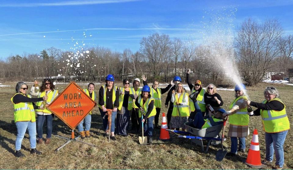 Local business owner Gina Sawtelle, seen here at center with a shovel, and her staff celebrate the official groundbreaking for Above & Beyond Catering's new wedding and events center on Shaw's Ridge Road in Sanford, Maine, on April 13, 2023.