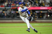 New York Mets pitcher Reed Garrett tries to get the ball to first base but commits a throwing error during the seventh inning of a baseball game against the Pittsburgh Pirates at Citi Field, Tuesday, April 16, 2024, in New York. (AP Photo/Seth Wenig)