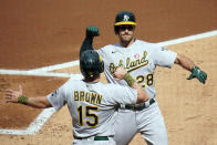 Oakland Athletics' Matt Olson (28) celebrates his two-run home run off Minnesota Twins' pitcher Jose Berrios with Seth Brown (15) in the first inning of a baseball game, Saturday, May 15, 2021, in Minneapolis. (AP Photo/Jim Mone)