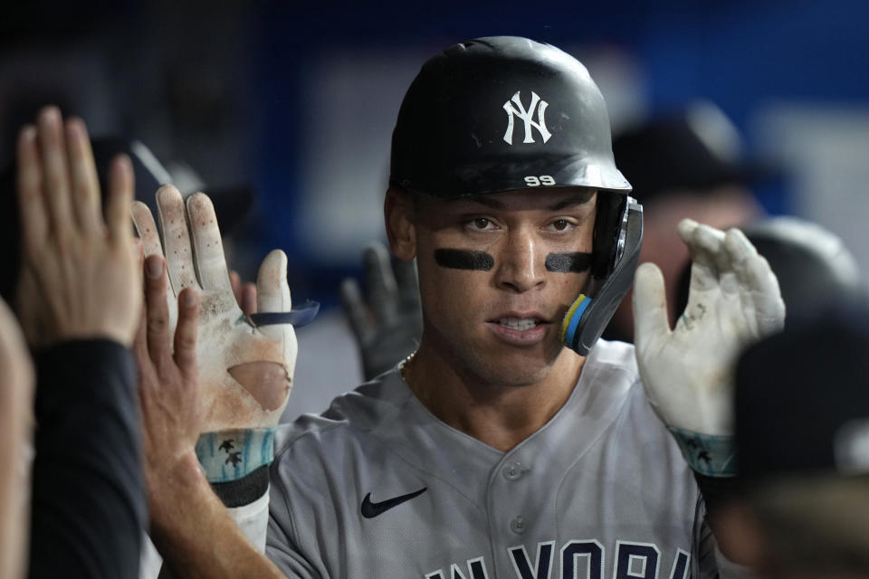 New York Yankees' Aaron Judge celebrates with teammates in the dugout after hitting a two-run home run against the Toronto Blue Jays during the seventh inning of a baseball game Wednesday, Sept. 27, 2023, in Toronto. (Frank Gunn/The Canadian Press via AP)