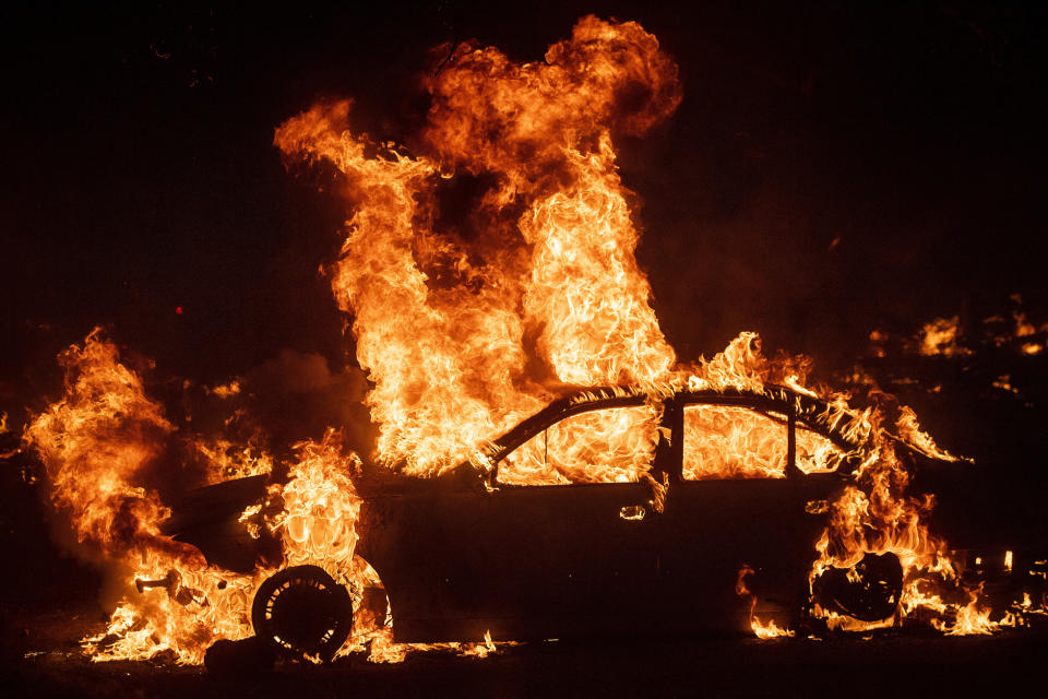 Flames from the Kincade Fire consume a car in the Jimtown community of unincorporated Sonoma County, Calif., Oct. 24, 2019. (AP Photo/Noah Berger)