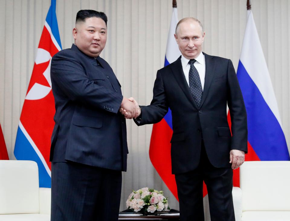 Russian President Vladimir Putin, right, and North Korea's leader Kim Jong Un shake hands during their meeting on Thursday in Vladivostok, Russia.