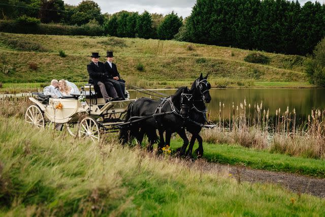 <p>SWNS</p> Lucinda Rose and Ian Brown ride in a horse-drawn carriage on their wedding day