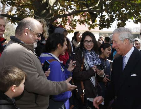 Britain's Prince Charles (R) greets fellow tourists during his visit to Mount Vernon, Virginia, the home of U.S. first President George Washington, March 18, 2015. REUTERS/Gary Cameron