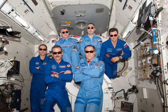 The International Space Station's Expedition 34 crew pose for a team portrait with sunglasses. The six men made time during their experiments and work aboard the ISS to watch the Super Bowl on February 3, 2013.