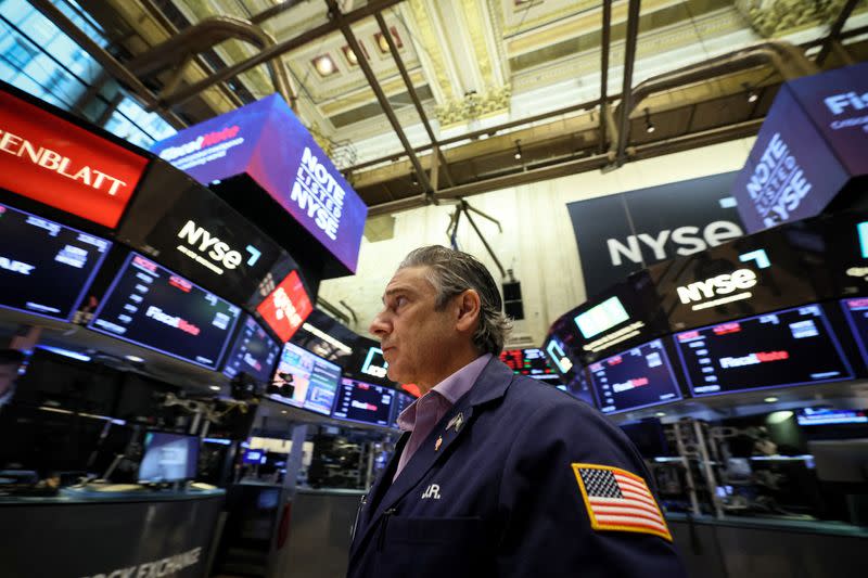 FILE PHOTO: Traders work on the floor of the NYSE in New York