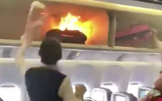 A flight attendant attempts to put out the fire with water from a bottle - Weibo