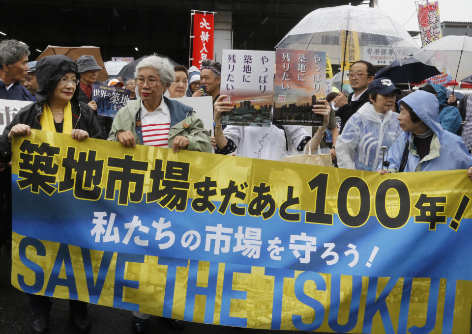 FILE - In this Sept. 29, 2018, file photo, people protest against the move of Tsukiji fish market in Tokyo. Japan's famed Tsukiji fish market is closing down on Saturday, Oct. 6, 2018, after eight decades, with shop owners and workers still doubting the safety of its replacement site. (AP Photo/Yuri Kageyama)