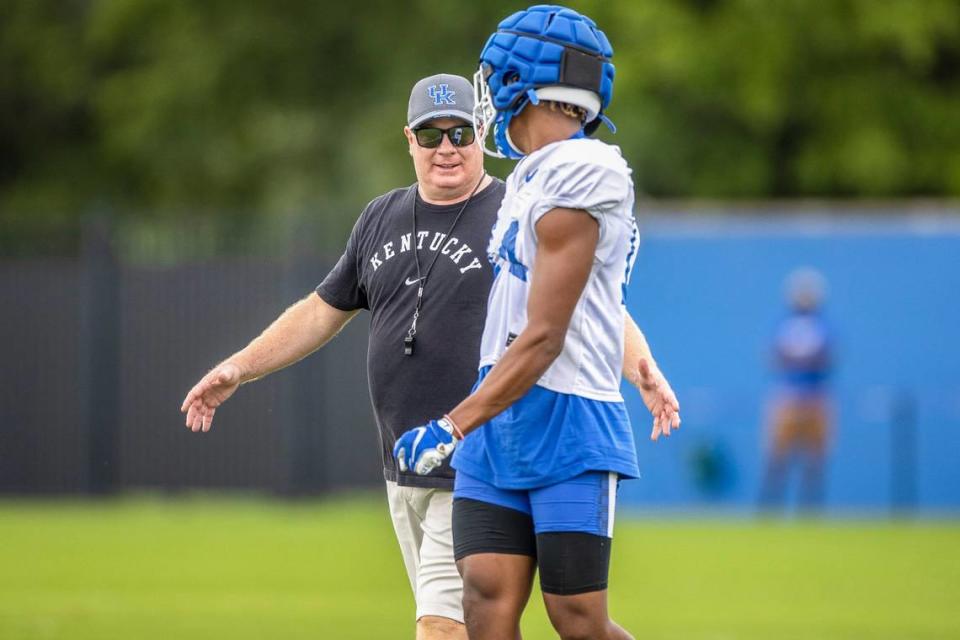 UK head coach Mark Stoops touched base with defensive back Carrington Valentine during Saturday’s open practice in Lexington.