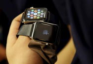 A staff holds Apple Watches after the watch went on display at an Apple Store in Beijing April 10, 2015. REUTERS/Kim Kyung-Hoon