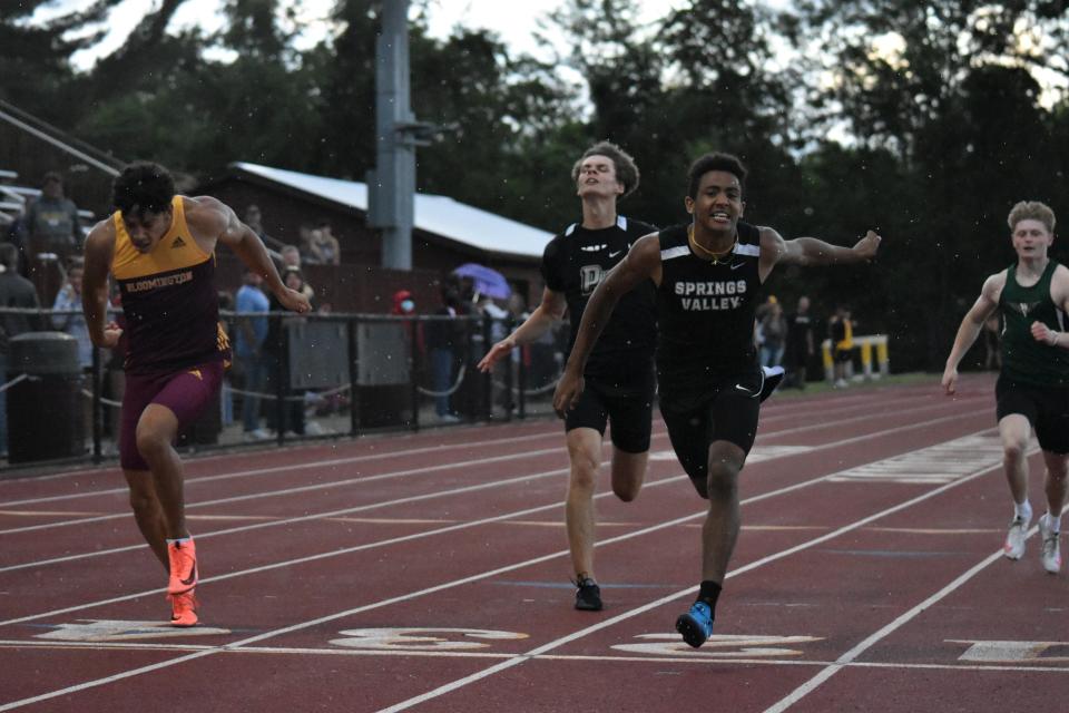 Conner Grimes dips across the finish line to secure a place at the State Finals. The senior finished second in the 200-meter dash at the 2022 Bloomington North Boys' Track and Field Regional.