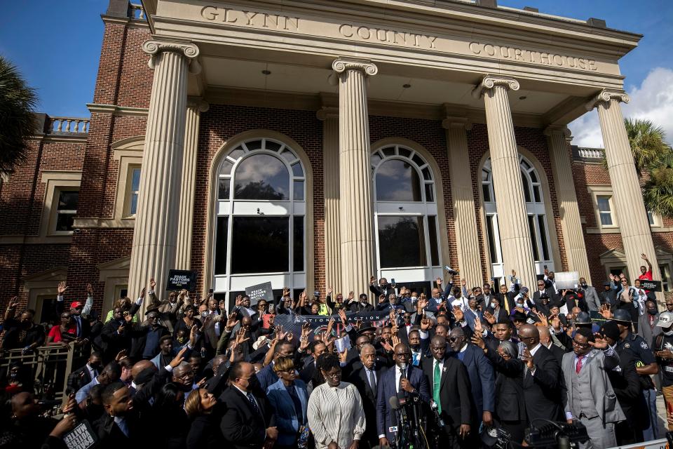 Pastor Jamal Bryant, bottom center, leads a group prayer for to nearly 750 pastors, supporters and family of Ahmaud Arbery gathered outside the Glynn County Courthouse during a Wall of Prayer event, on Nov. 18, 2021, in Brunswick, Ga.
