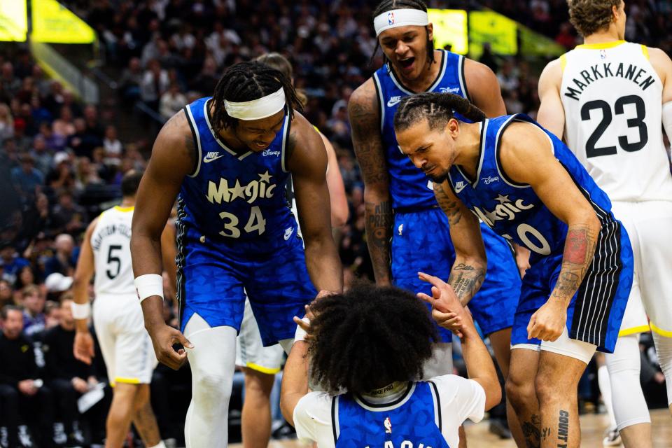 Orlando Magic teammates cheer on Orlando Magic guard <a class="link " href="https://sports.yahoo.com/nba/players/10095" data-i13n="sec:content-canvas;subsec:anchor_text;elm:context_link" data-ylk="slk:Anthony Black;sec:content-canvas;subsec:anchor_text;elm:context_link;itc:0">Anthony Black</a> (0) as they help him up after a foul during an NBA basketball game between the Utah Jazz and Orlando Magic at the Delta Center in Salt Lake City on Thursday, Nov. 2, 2023. | Megan Nielsen, Deseret News