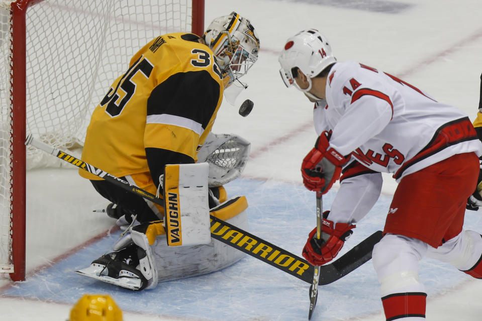 Pittsburgh Penguins goaltender Tristan Jarry (35) stops a shot by Carolina Hurricanes' Justin Williams (14) during the first period of an NHL hockey game, Sunday, March 8, 2020, in Pittsburgh. (AP Photo/Keith Srakocic)