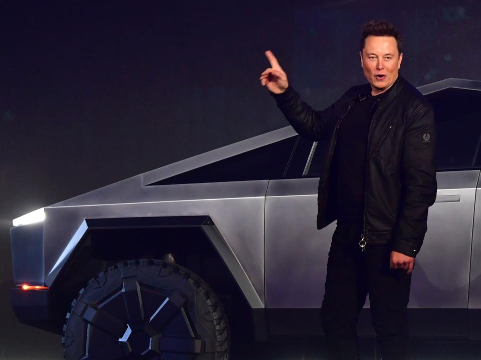Tesla CEO Elon Musk gestures toward a Cybertruck