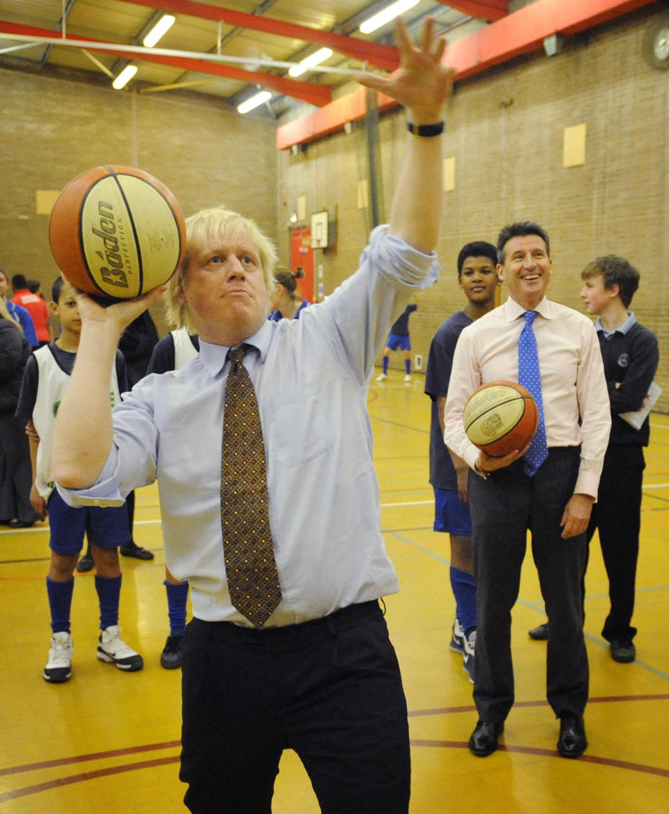 London 2012 Chairman Lord Coe (right) watches as London Mayor Boris Johnson plays basketball with pupils from Chiswick Community School in west London where they told the school how many Olympic tickets they would receive through the London 2012 Ticketshare scheme.