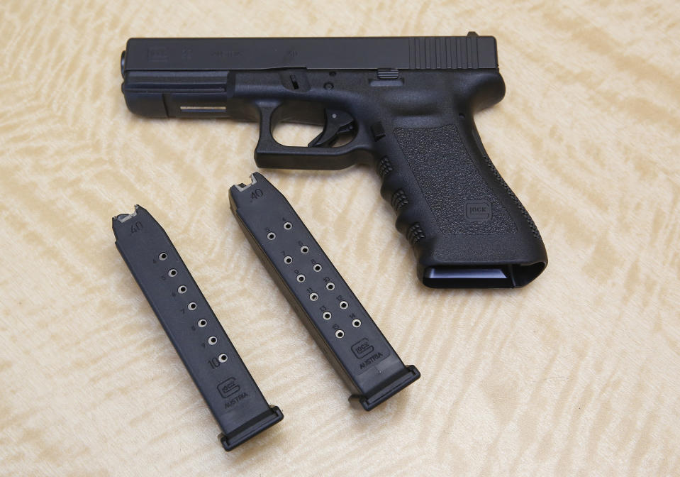 FILE - In this June 27, 2017, file photo, a semi-automatic hand gun is displayed with a 10 shot magazine, left, and a 15 shot magazine, right, at a gun store in Elk Grove, Calif. With Democrats controlling the presidency and Congress, Republican state lawmakers concerned about the possibility of new federal gun control laws aren't waiting to react. Legislation in at least a dozen states seeks to nullify any new restrictions, such as ammunition limits or a ban on certain types of weapons. (AP Photo/Rich Pedroncelli, File)