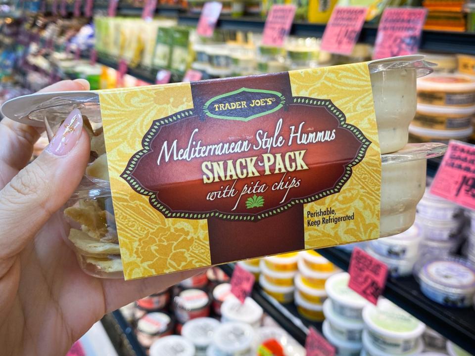 hand holding package of Mediterranean snack pack at trader joes