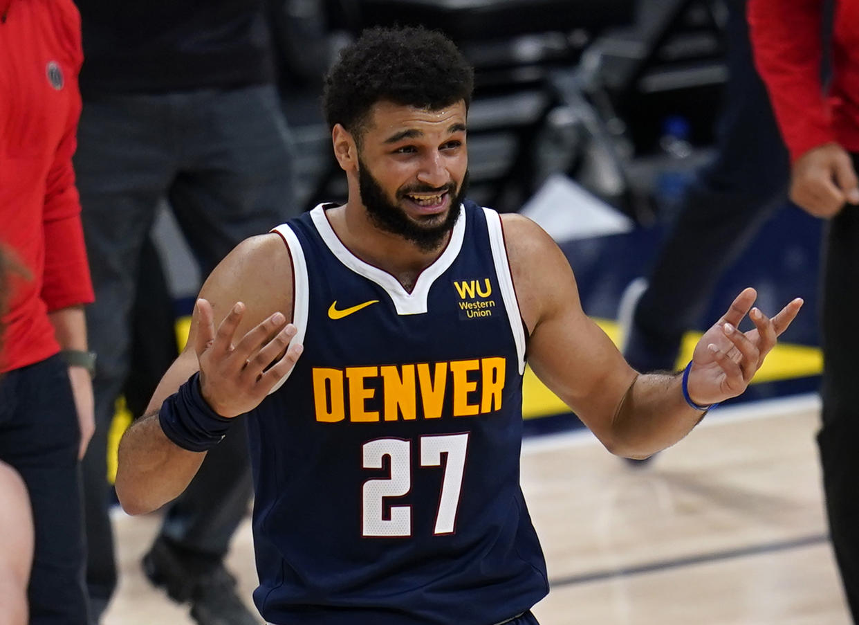 Denver Nuggets guard Jamal Murray reacts to the team's loss to the Washington Wizards in an NBA basketball game Thursday, Feb. 25, 2021, in Denver. (AP Photo/Jack Dempsey)