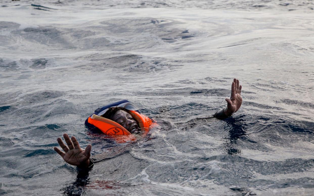 A migrant is rescued from the sea in November. On Tuesday a Spanish NGO accused the Libyan coastguard of leaving a woman and a toddler to die in the Mediterranean - AFP