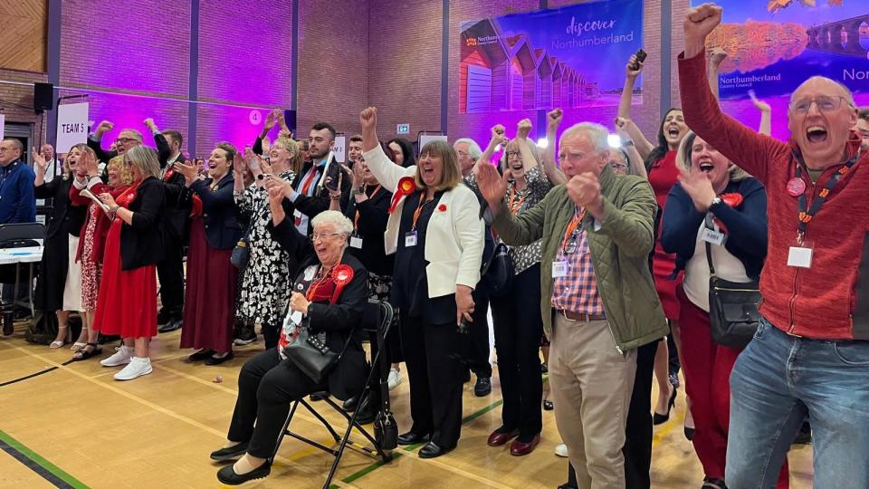 A large group of people cheers