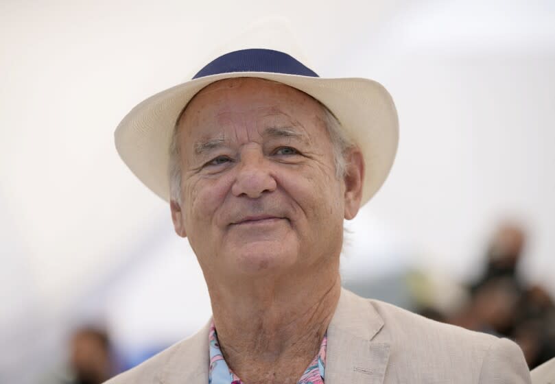 A man posing in a white hat