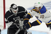 Los Angeles Kings goaltender Calvin Petersen, left, stops a shot next to St. Louis Blues center Brayden Schenn (10) during the second period of an NHL hockey game Friday, March 5, 2021, in Los Angeles. (AP Photo/Marcio Jose Sanchez)