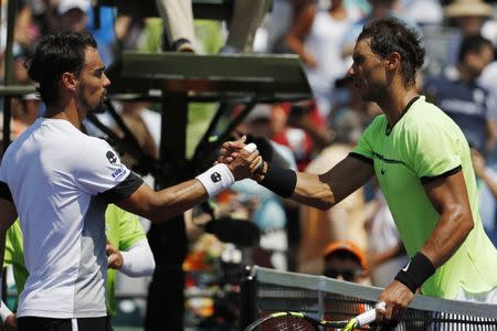 Mar 31, 2017; Miami, FL, USA; Rafael Nadal of Spain (R) shakes hands with Fabio Fognini of Italy (L) after their match during a men's singles semi-final in the 2017 Miami Open at Brandon Park Tennis Center. Nadal won 6-1, 7-5. Geoff Burke-USA TODAY Sports