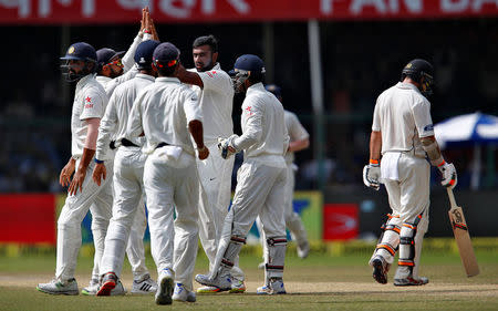 Cricket - India v New Zealand - First Test cricket match - Green Park Stadium, Kanpur, India - 25/09/2016. India's Ravichandran Ashwin celebrates with teammates after taking the wicket of New Zealand's Tom Latham. REUTERS/Danish Siddiqui