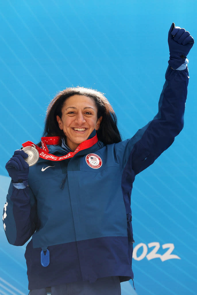 Meyers holding up her silver medal