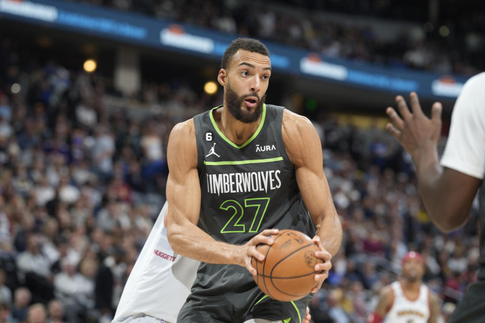 FILE - Minnesota Timberwolves center Rudy Gobert controls the ball in the second half of Game 5 of an NBA basketball first-round playoff series against the Denver Nuggets, April 25, 2023, in Denver. Karl-Anthony Towns missed 52 games to injury last season during Rudy Gobert's debut, turning Minnesota's experiment of pairing two big men together into a false start. The Timberwolves are banking on Gobert being more comfortable in his second year and Towns staying healthy. (AP Photo/David Zalubowski, File)