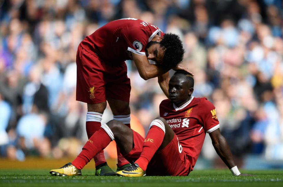 <p>Mohamed Salah of Liverpool comforts Sadio Mane of Liverpool after he was to sent off </p>