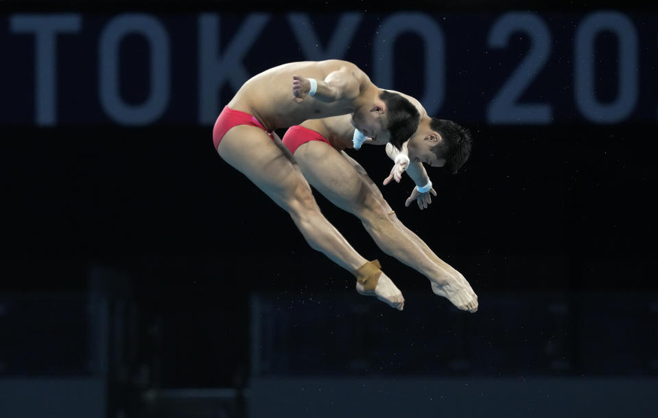 Yuan Cao and Aisen Chen of China compete during the men's synchronized 10m platform diving final at the Tokyo Aquatics Centre at the 2020 Summer Olympics, Monday, July 26, 2021, in Tokyo, Japan. (AP Photo/Dmitri Lovetsky)