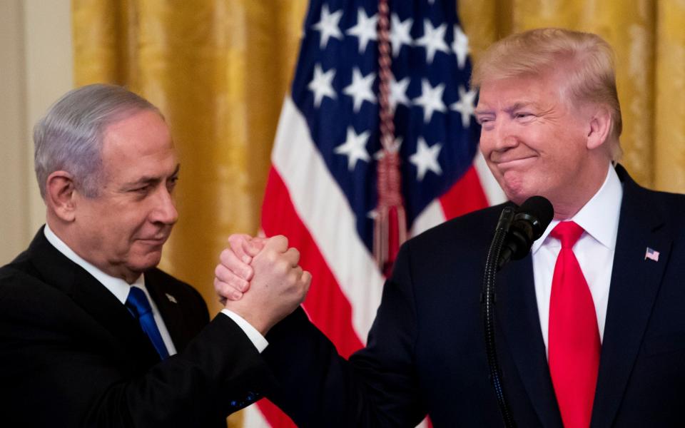 US President Donald J. Trump (R) shakes hands with Prime Minister of Israel Benjamin Netanyahu while unveiling his Middle East peace plan in the East Room of the White House, in Washington, DC, USA, 28 January 2020 - MICHAEL REYNOLDS/REX