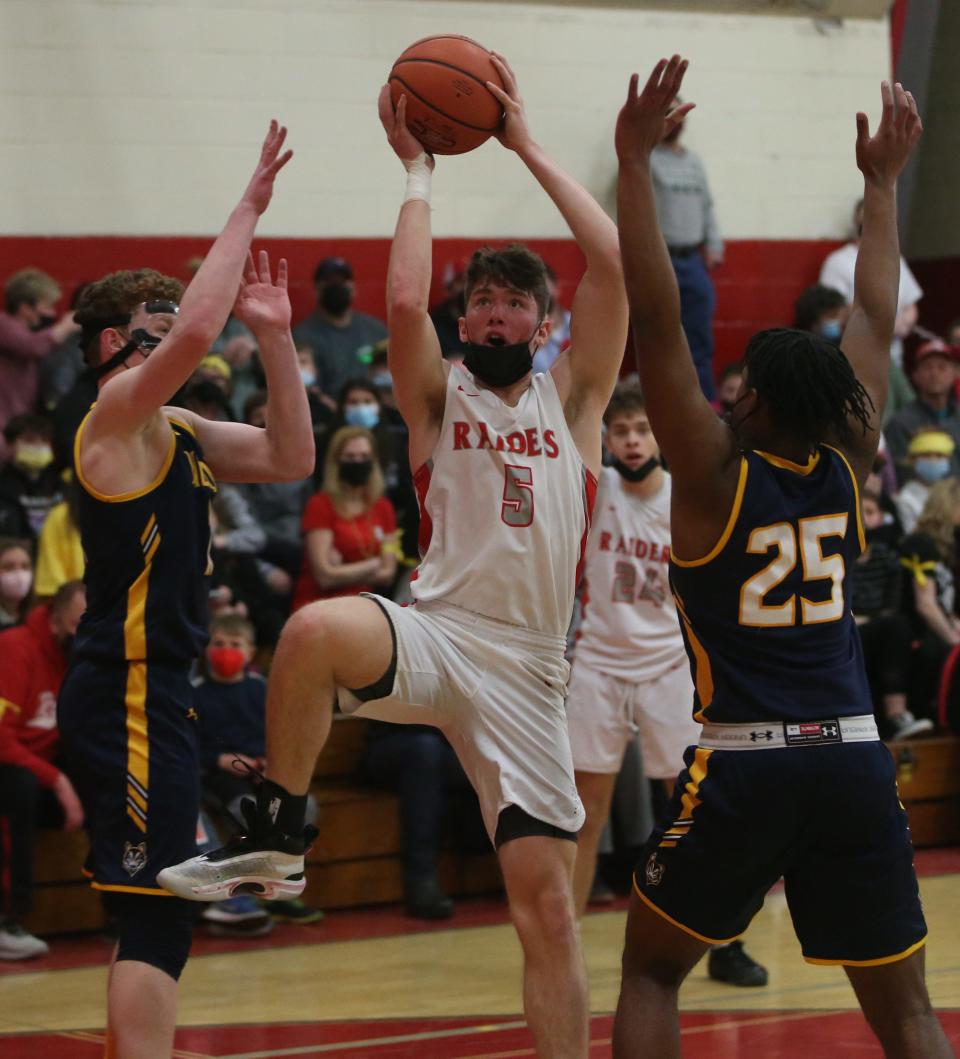 Red Hook's Brendan Donohue takes a jump shot as Highland's, from left, Aidan Wiser and Dylan Durandis cover him during Friday's game on February 18, 2022. 