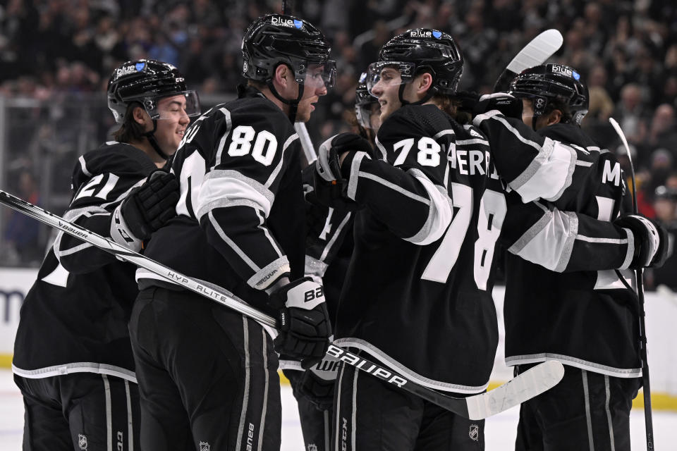 Los Angeles Kings center Pierre-Luc Dubois (80) celebrates scoring a goal with right wing Alex Laferriere (78) and teammates during the second period of an NHL hockey game against the Edmonton Oilers in Los Angeles, Saturday, Feb. 10, 2024. (AP Photo/Alex Gallardo)