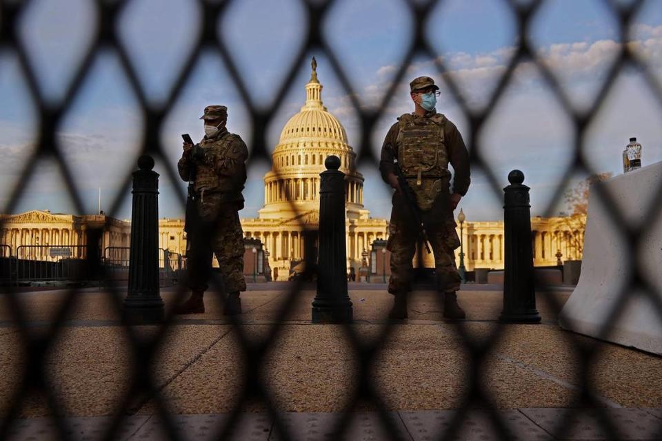 WASHINGTON, DC - JANUARY 14: Members of the New York National Guard stand guard along the fence that surrounds the U.S. Capitol the day after the House of Representatives voted to impeach President Donald Trump for the second time January 14, 2021 in Washington, DC. Thousands of National Guard troops have been activated to protect the nation’s capital against threats surrounding President-elect Joe Biden’s inauguration and to prevent a repeat of last week’s deadly insurrection at the U.S. Capitol. (Photo by Chip Somodevilla/Getty Images)