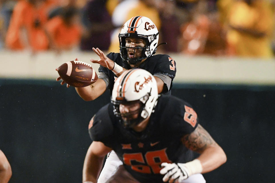 Oklahoma State quarterback Spencer Sanders (3) takes a snap during the second half of an NCAA college football game against Arizona State, Saturday, Sept. 10, 2022, in Stillwater, Okla. (AP Photo/Brody Schmidt)