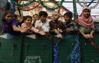 Children ask for offerings as they travel in truck on their way to participate in a procession to mark Eid-e-Milad-ul-Nabi, or birthday celebrations of Prophet Mohammad in Mumbai January 14, 2014. REUTERS/Danish Siddiqui (INDIA - Tags: RELIGION SOCIETY)